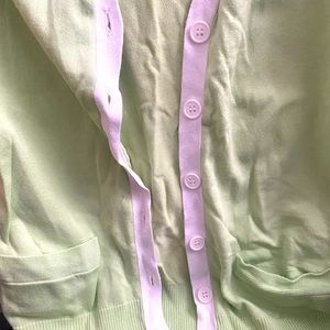 Romeo size large pale green cardigan with white piping.